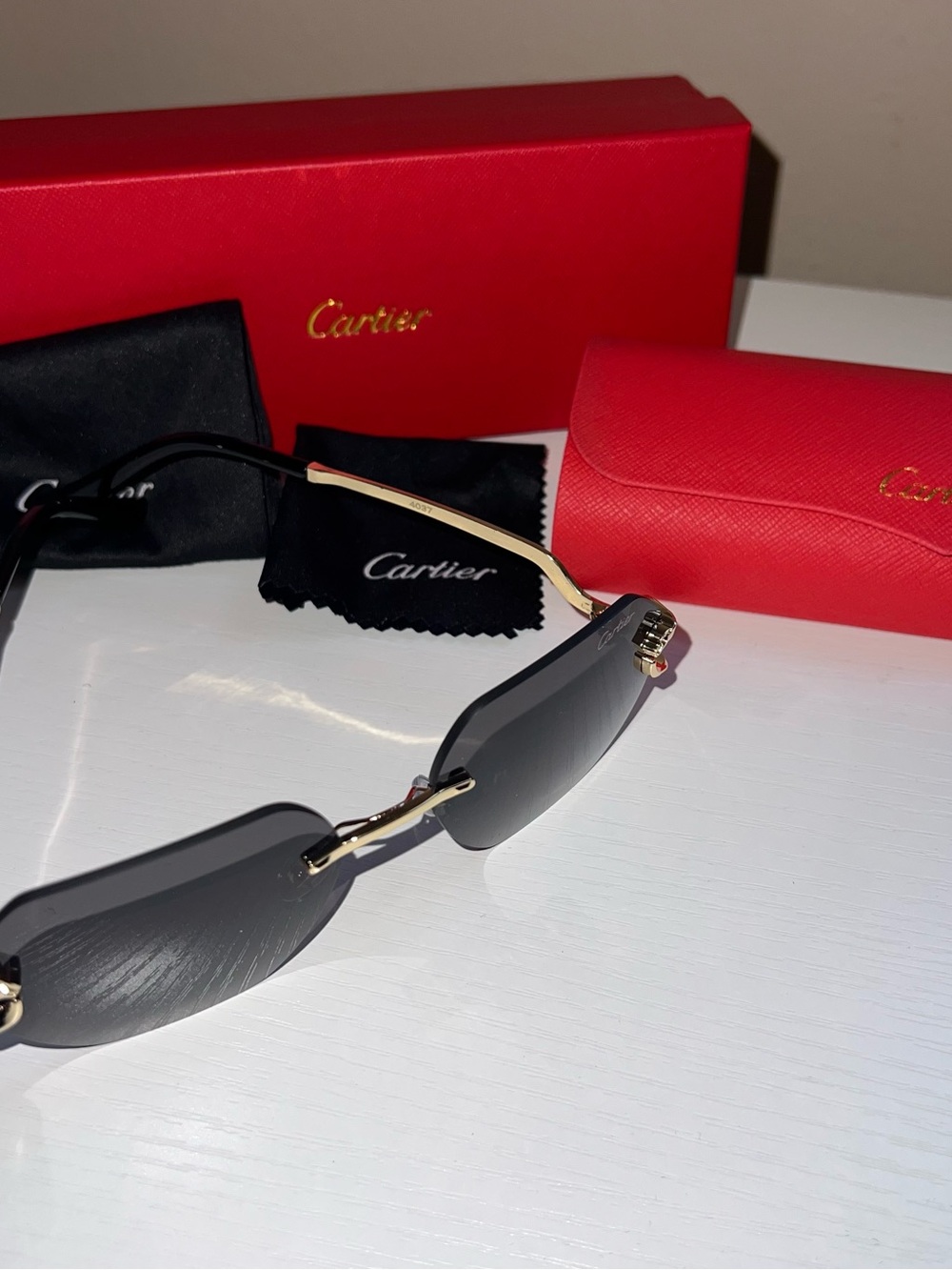 Cartier Women's Rimless Sunglasses — Black Lenses with Gold Temples